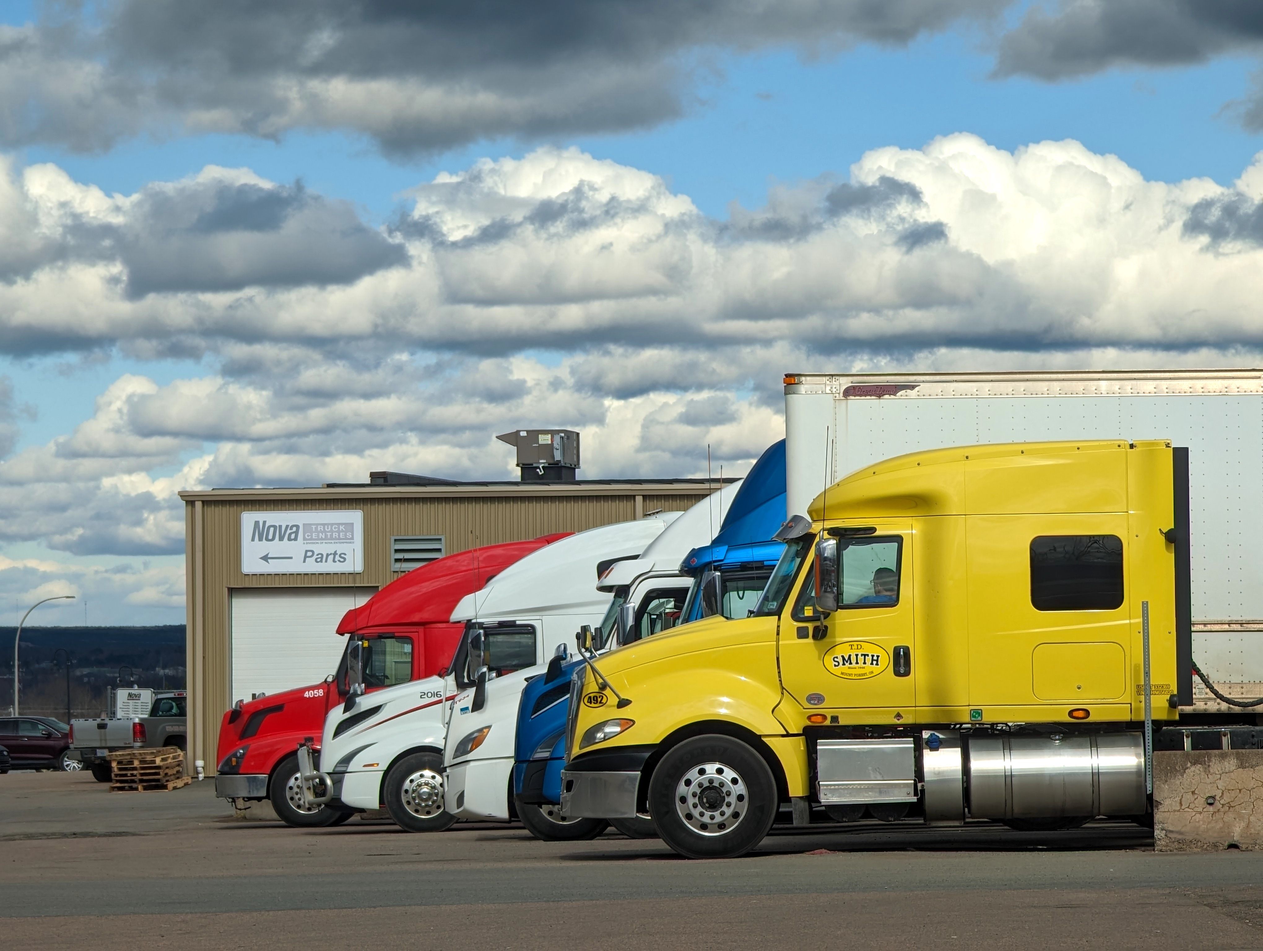 Parked semi-trucks outside a parts warehouse